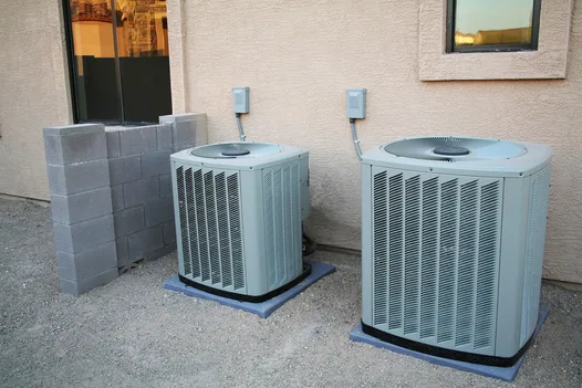 Newly installed outdoor AC condensing units on concrete pads