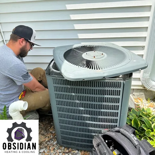 Obsidian technician tuning up an outdoor air conditioner condenser