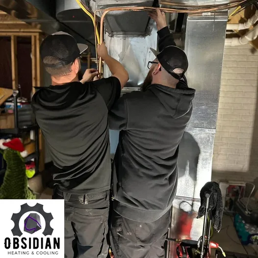 Obsidian technicians running copper line-set and ductwork for a heat pump system