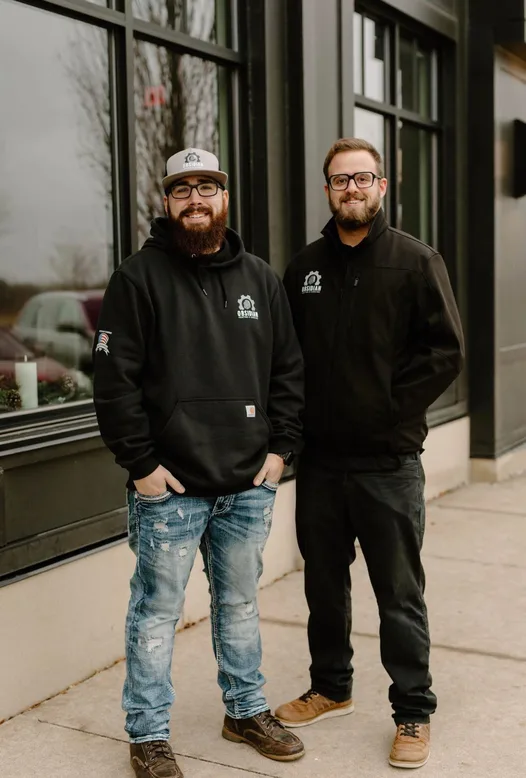 Obsidian Heating and Cooling owners outside the storefront