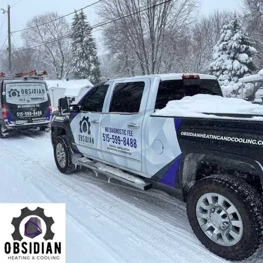 Obsidian service truck and van on a snowy Urbandale, IA street
